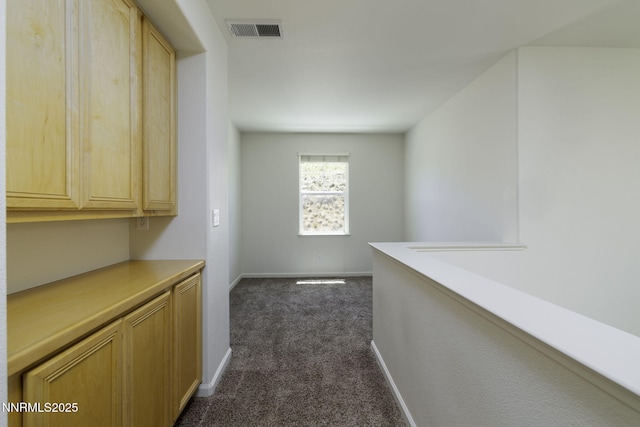 7680 Stone Bluff Way, Reno, NV 89523 - corridor featuring dark colored carpet and baseboards