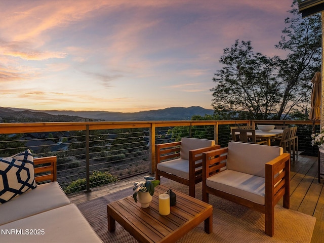 4721 W Creek Ridge Trl, Reno, NV 89519 - deck at dusk with a mountain view, outdoor lounge area, and outdoor dining area