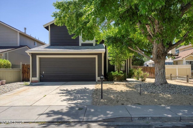 2719 Chavez Dr, Reno, NV 89502 - view of property hidden behind natural elements featuring a garage and concrete driveway