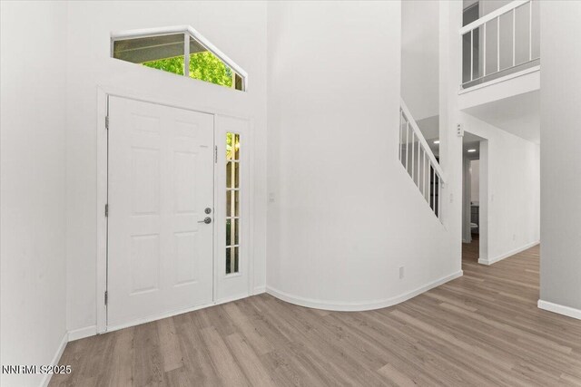 2719 Chavez Dr, Reno, NV 89502 - entryway featuring a towering ceiling, wood finished floors, and stairway