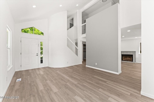 2719 Chavez Dr, Reno, NV 89502 - foyer entrance featuring a towering ceiling, wood finished floors, a fireplace, recessed lighting, and stairway