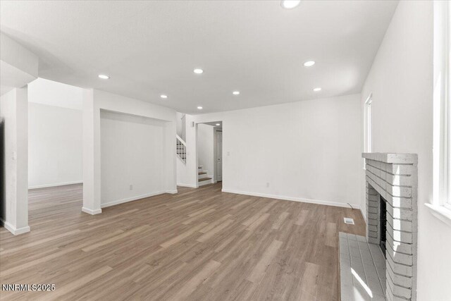 2719 Chavez Dr, Reno, NV 89502 - unfurnished living room with stairway, light wood-style flooring, recessed lighting, and a fireplace