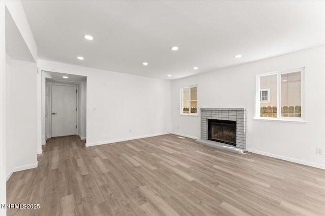 2719 Chavez Dr, Reno, NV 89502 - unfurnished living room featuring light wood finished floors, recessed lighting, and a fireplace
