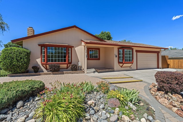2095 Kings Row, Reno, NV 89503 - ranch-style house with a chimney, a garage, and driveway