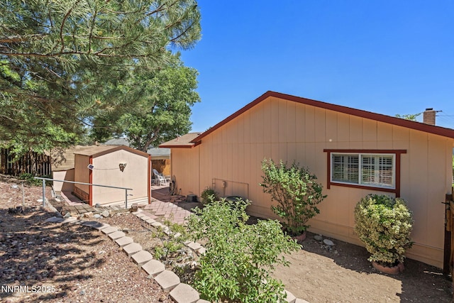 2095 Kings Row, Reno, NV 89503 - view of home's exterior featuring a storage unit and a chimney
