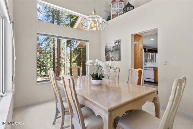 917 Jennifer St, Incline Village, NV 89451 - dining space featuring a chandelier, light colored carpet, and a towering ceiling