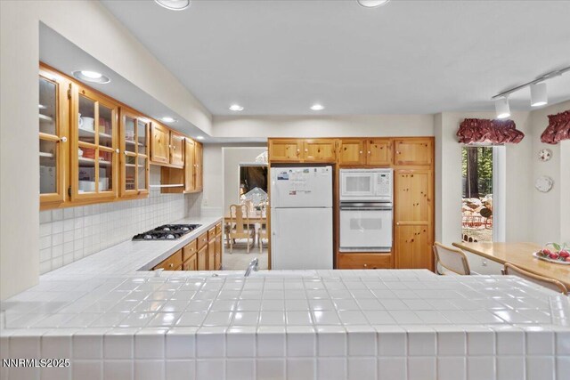 917 Jennifer St, Incline Village, NV 89451 - kitchen with white appliances, backsplash, glass insert cabinets, tile countertops, and recessed lighting