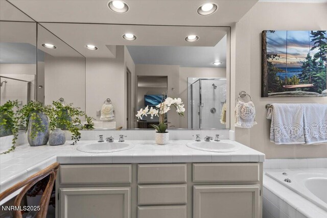 917 Jennifer St, Incline Village, NV 89451 - bathroom featuring a shower stall, double vanity, a garden tub, and recessed lighting