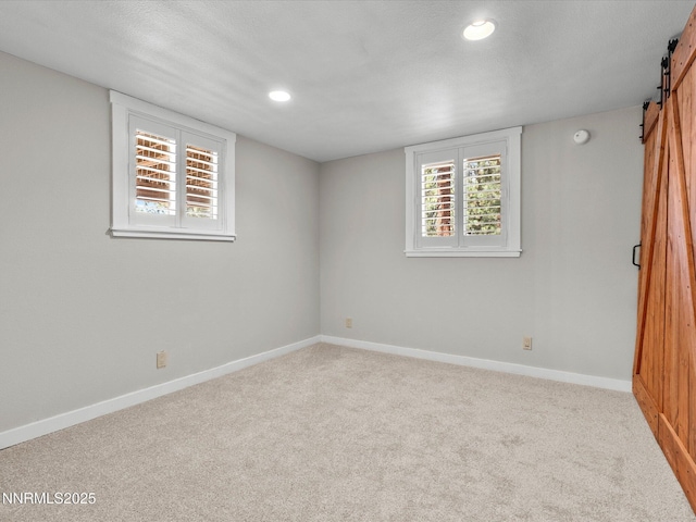 699 Lakeview Dr, Zephyr Cove, NV 89448 - basement with a barn door, carpet flooring, recessed lighting, and plenty of natural light