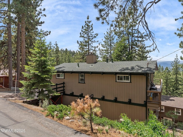 699 Lakeview Dr, Zephyr Cove, NV 89448 - view of property exterior featuring a chimney and roof with shingles