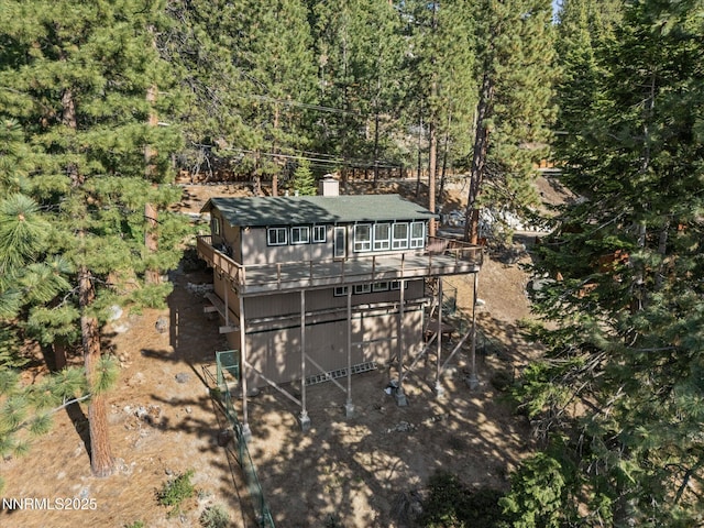 699 Lakeview Dr, Zephyr Cove, NV 89448 - back of house with a chimney, a deck, a forest view, and stairway