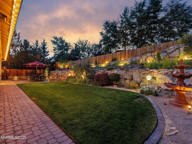 1486 Lambrays Ct, Sparks, NV 89436 - yard at dusk with a patio and a fenced backyard