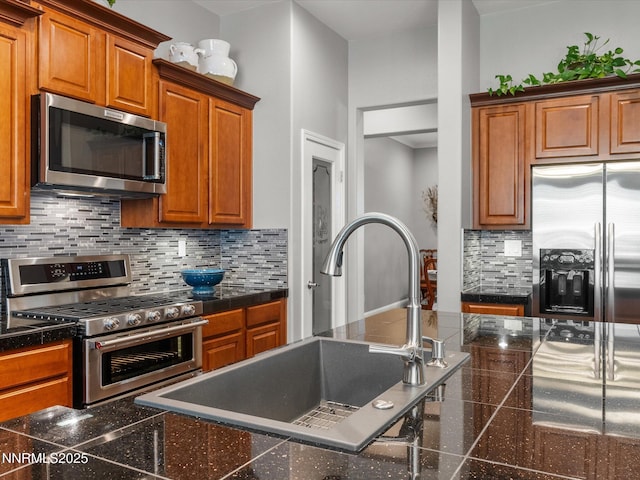 1486 Lambrays Ct, Sparks, NV 89436 - kitchen featuring stainless steel appliances, granite floors, brown cabinets, tile countertops, and tasteful backsplash