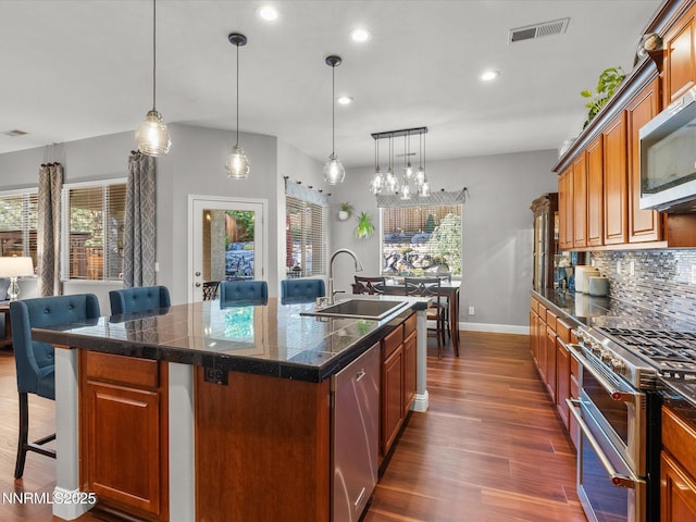 1486 Lambrays Ct, Sparks, NV 89436 - kitchen with tile counters, appliances with stainless steel finishes, a breakfast bar area, plenty of natural light, and recessed lighting