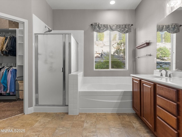 1486 Lambrays Ct, Sparks, NV 89436 - bathroom featuring a stall shower, a bath, a spacious closet, and vanity