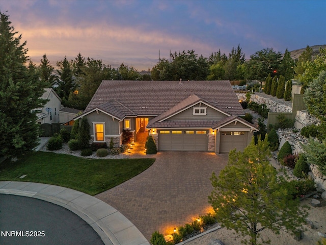 1486 Lambrays Ct, Sparks, NV 89436 - view of front facade featuring stone siding, an attached garage, decorative driveway, and a front yard