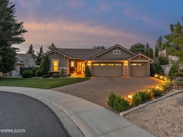 1486 Lambrays Ct, Sparks, NV 89436 - craftsman-style home featuring an attached garage, decorative driveway, stone siding, and a yard
