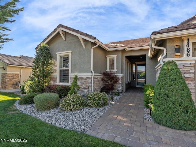 1486 Lambrays Ct, Sparks, NV 89436 - view of front of house featuring stone siding, a tile roof, and stucco siding