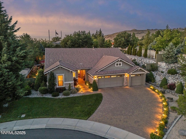 1486 Lambrays Ct, Sparks, NV 89436 - view of front facade featuring stone siding, a garage, a lawn, driveway, and a tile roof