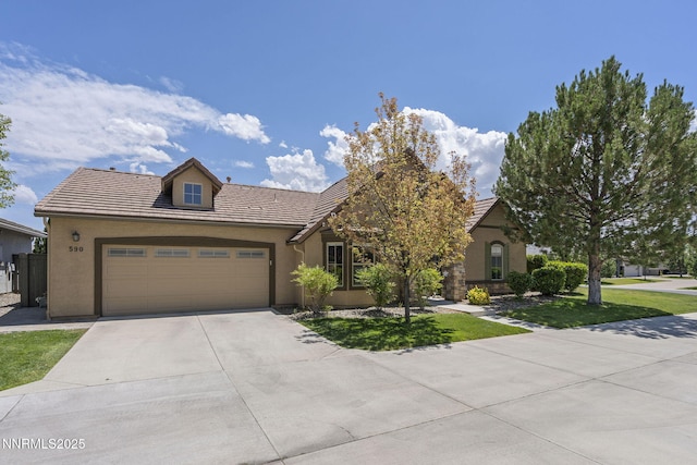 590 S Sand Crane Cir, Sparks, NV 89436 - view of front of house featuring concrete driveway, a garage, a tiled roof, stucco siding, and a front lawn
