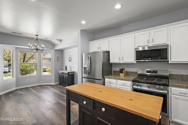 590 S Sand Crane Cir, Sparks, NV 89436 - kitchen with stainless steel appliances, wooden counters, white cabinetry, a chandelier, and dark wood-style floors