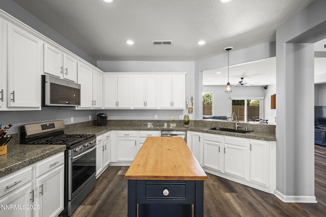 590 S Sand Crane Cir, Sparks, NV 89436 - kitchen featuring stainless steel appliances, butcher block countertops, white cabinets, dark wood-type flooring, and recessed lighting