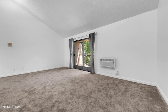 2450 Lymbery St Unit 331, Reno, NV 89509 - spare room with an AC wall unit, lofted ceiling, carpet floors, and a textured ceiling