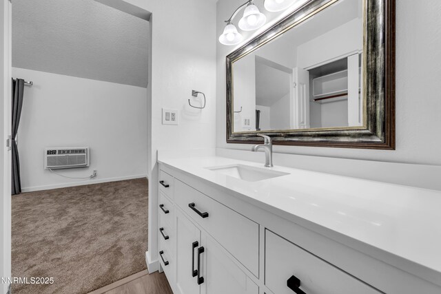 2450 Lymbery St Unit 331, Reno, NV 89509 - bathroom with vanity, a wall mounted AC, and vaulted ceiling