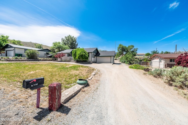 8720 Aquifer Way, Reno, NV 89506 - single story home featuring dirt driveway, a front yard, and an attached garage