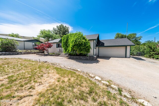 8720 Aquifer Way, Reno, NV 89506 - view of front of house featuring a garage and dirt driveway