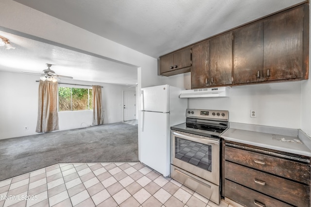 8720 Aquifer Way, Reno, NV 89506 - kitchen featuring stainless steel range with electric stovetop, light carpet, under cabinet range hood, freestanding refrigerator, and open floor plan