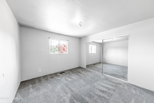 8720 Aquifer Way, Reno, NV 89506 - unfurnished bedroom with carpet flooring, a textured ceiling, and a closet