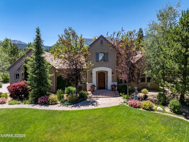 16956 Rue Du Parc Ave, Reno, NV 89511 - view of front of house featuring stucco siding, a front lawn, and a mountain view