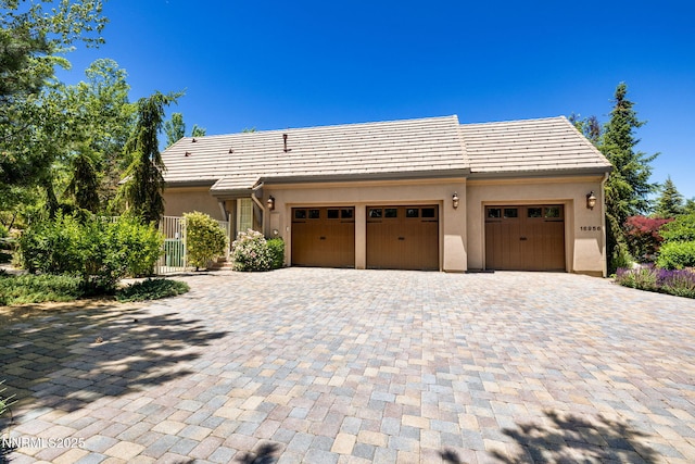 16956 Rue Du Parc Ave, Reno, NV 89511 - view of front of home with a garage, decorative driveway, and stucco siding