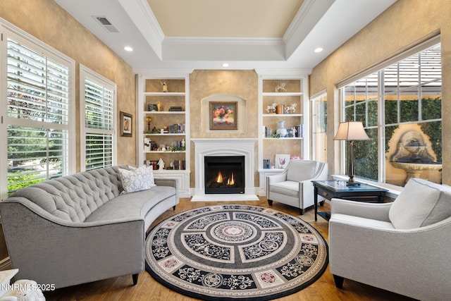 16956 Rue Du Parc Ave, Reno, NV 89511 - living area featuring built in features, crown molding, a large fireplace, wood finished floors, and recessed lighting