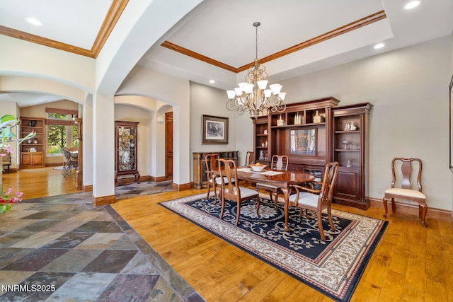 16956 Rue Du Parc Ave, Reno, NV 89511 - dining area featuring arched walkways, crown molding, recessed lighting, dark wood-style floors, and a chandelier