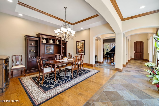 16956 Rue Du Parc Ave, Reno, NV 89511 - dining space with arched walkways, crown molding, recessed lighting, a chandelier, and wood finished floors