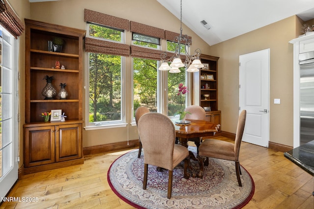 16956 Rue Du Parc Ave, Reno, NV 89511 - dining area with lofted ceiling, light wood-type flooring, and a chandelier