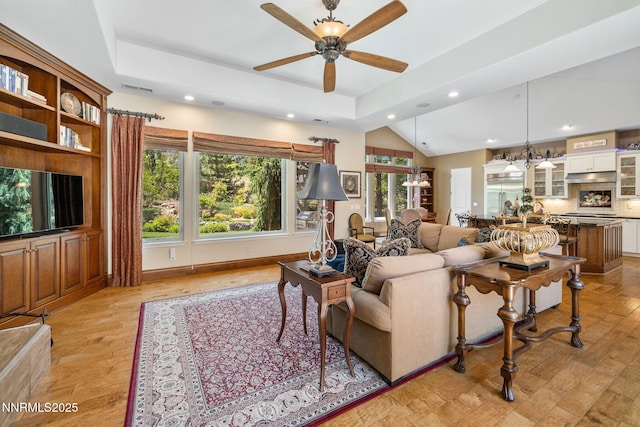 16956 Rue Du Parc Ave, Reno, NV 89511 - living area with recessed lighting, a ceiling fan, a tray ceiling, light wood-style flooring, and a chandelier