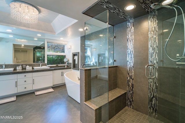 275 Chukkar Dr, Glenbrook, NV 89413 - bathroom with double vanity, a stall shower, a freestanding tub, and a chandelier