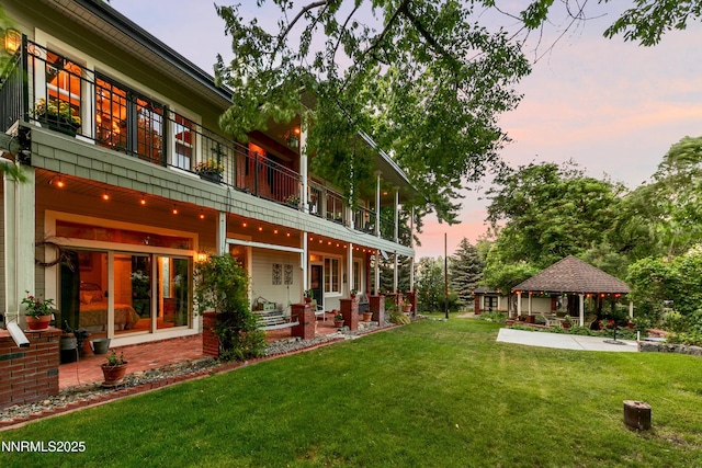 171 Mill St, Genoa, NV 89411 - yard at dusk with a gazebo, a balcony, a lawn, and a patio area