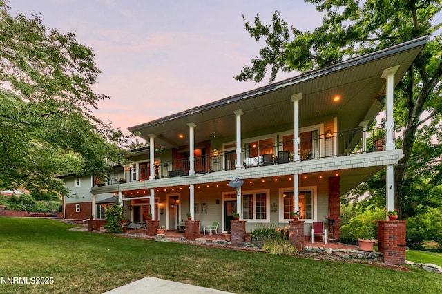171 Mill St, Genoa, NV 89411 - view of front of house with a balcony, a yard, and a porch