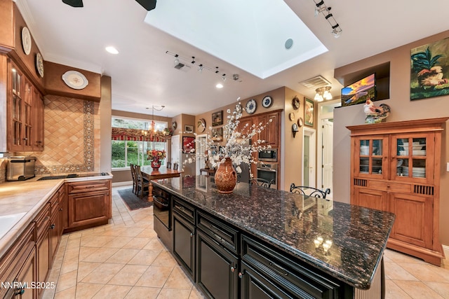 171 Mill St, Genoa, NV 89411 - kitchen featuring track lighting, stainless steel appliances, light tile patterned flooring, a chandelier, and recessed lighting