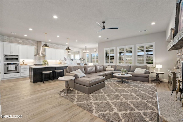 10 Diamond Strm Ct, Sparks, NV 89441 - living area featuring a ceiling fan, recessed lighting, plenty of natural light, a fireplace, and light wood finished floors