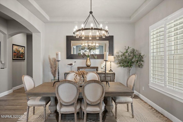 10 Diamond Strm Ct, Sparks, NV 89441 - dining room featuring a chandelier, arched walkways, wood finished floors, and healthy amount of natural light