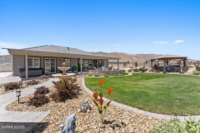 10 Diamond Strm Ct, Sparks, NV 89441 - rear view of house featuring a gazebo, a patio area, a hot tub, a mountain view, and stucco siding