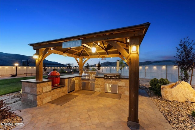 10 Diamond Strm Ct, Sparks, NV 89441 - view of patio with exterior kitchen, a gazebo, and a mountain view