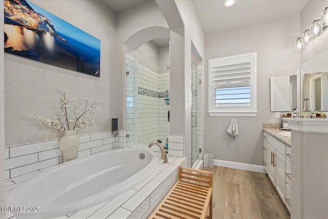 10 Diamond Strm Ct, Sparks, NV 89441 - full bathroom with vanity, a garden tub, a shower stall, and wood finished floors