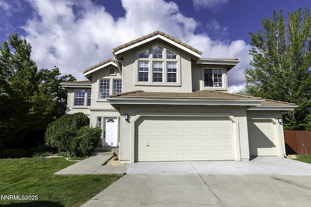 3323 Deer Ridge Ct, Reno, NV 89509 - traditional home with a garage, driveway, a tiled roof, and stucco siding