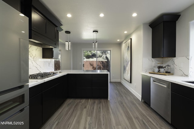 3323 Deer Ridge Ct, Reno, NV 89509 - kitchen featuring appliances with stainless steel finishes, a peninsula, backsplash, dark cabinetry, and recessed lighting